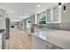 Stylish kitchen boasts white cabinets, quartz countertops, and stainless steel appliances at 2122 S Zephyr St, Lakewood, CO 80227