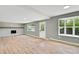 Spacious living room with fireplace, light hardwood floors, and natural light at 2122 S Zephyr St, Lakewood, CO 80227