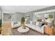 Bright living room with hardwood floors, neutral walls, stylish furniture, and open floor plan at 2122 S Zephyr St, Lakewood, CO 80227