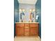 Stylish bathroom with a double vanity, granite countertops, and patterned wallpaper at 2849 E Cresthill Ave, Centennial, CO 80121