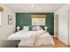 Spacious primary bedroom features a ceiling fan, hardwood floors, and a green accent wall at 2849 E Cresthill Ave, Centennial, CO 80121