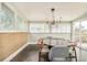 Elegant dining room featuring stylish lighting, wainscoting, and access to the outdoor space at 2849 E Cresthill Ave, Centennial, CO 80121