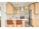 Modern kitchen with stainless steel appliances, quartz counters, and light wood cabinets at 2849 E Cresthill Ave, Centennial, CO 80121