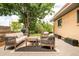 Outdoor patio with comfortable seating, stylish rug, ambient string lights, and a landscaped backyard at 2849 E Cresthill Ave, Centennial, CO 80121