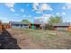 Large backyard with a shed, pergola, partially fenced-in area, and the home in the background at 128 S Lowell Blvd, Denver, CO 80219