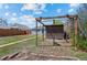 The backyard is spacious and includes a shed, pergola, partial fence, and foliage at 128 S Lowell Blvd, Denver, CO 80219
