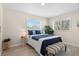 Cozy bedroom with neutral colors, a comfortable bed, and natural light at 128 S Lowell Blvd, Denver, CO 80219