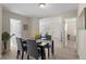Elegant dining area with a stylish table set, complemented by abundant natural light and a view into the living room at 128 S Lowell Blvd, Denver, CO 80219
