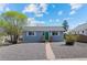 Charming single-story home featuring a well-maintained yard and a welcoming green front door at 128 S Lowell Blvd, Denver, CO 80219