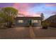 Charming single-story home featuring a well-maintained yard and a welcoming green front door at 128 S Lowell Blvd, Denver, CO 80219