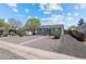 Charming home featuring a driveway, front yard, and a green-colored front door at 128 S Lowell Blvd, Denver, CO 80219