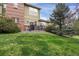 A spacious backyard with lush green lawn, mature trees, and patio area is ready for entertaining at 12831 King St, Broomfield, CO 80020