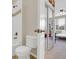 Clean bathroom with toilet and view into the bedroom and closet with mirror doors at 12831 King St, Broomfield, CO 80020