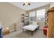 This cozy bedroom has neutral walls and carpet, with window views and storage solutions at 12831 King St, Broomfield, CO 80020