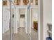 Hallway with closet doors and access to bathrooms at 12831 King St, Broomfield, CO 80020