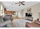 Open concept living area with a fireplace, and views into the kitchen at 12831 King St, Broomfield, CO 80020