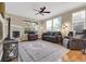 Comfortable living room with a fireplace, ceiling fan, and large windows providing natural light at 12831 King St, Broomfield, CO 80020