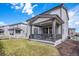 Covered patio with backyard access, grassy area, and woodchip border at 3455 Cade Ct, Castle Rock, CO 80104