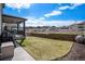 Backyard with a covered patio, grill, and grassy area at 3455 Cade Ct, Castle Rock, CO 80104