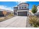 Two-story house with gray siding, stone accents, and a two-car garage at 3455 Cade Ct, Castle Rock, CO 80104