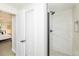 Hallway view of a modern bathroom with a walk-in shower featuring a rainfall shower head at 6338 W 92Nd Pl, Westminster, CO 80031