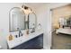 Elegant bathroom with double vanity, decorative mirrors, and modern lighting at 6338 W 92Nd Pl, Westminster, CO 80031
