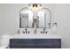 Modern bathroom with double sinks, sleek fixtures, and contemporary mirrors at 6338 W 92Nd Pl, Westminster, CO 80031