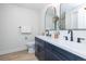 Modern bathroom featuring dual sinks, sleek dark cabinets, white countertop and updated fixtures at 6338 W 92Nd Pl, Westminster, CO 80031