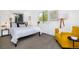 Cozy bedroom featuring a queen bed, a bright window view, and a comfortable yellow armchair at 6338 W 92Nd Pl, Westminster, CO 80031