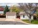 Charming home exterior with detached garage, landscaped yard, and mature trees at 6338 W 92Nd Pl, Westminster, CO 80031