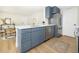 Charming kitchen with blue cabinets, stainless appliances, white countertops and modern gold hardware at 6338 W 92Nd Pl, Westminster, CO 80031