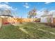 Large backyard with grassy area, gravel patio, and plenty of space for outdoor activities at 3825 W 73Rd Ave, Westminster, CO 80030