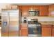 Modern kitchen with stainless steel appliances and wood cabinets at 3825 W 73Rd Ave, Westminster, CO 80030