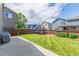 Beautifully maintained backyard with a trampoline, green lawn, and privacy fence at 4935 Apollo Bay Dr, Highlands Ranch, CO 80130