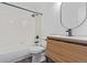 Updated bathroom with tub and shower, modern vanity, and black fixtures at 4935 Apollo Bay Dr, Highlands Ranch, CO 80130