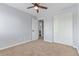 A bright bedroom featuring a ceiling fan, and a closet with access to a secondary room at 4935 Apollo Bay Dr, Highlands Ranch, CO 80130