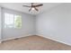 A bright bedroom featuring a ceiling fan, and a large window for ample natural light at 4935 Apollo Bay Dr, Highlands Ranch, CO 80130