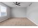 A spacious bedroom featuring a modern ceiling fan, carpeted flooring, and a large window for natural light at 4935 Apollo Bay Dr, Highlands Ranch, CO 80130