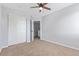A bright bedroom featuring a ceiling fan, and a closet with access to a secondary room at 4935 Apollo Bay Dr, Highlands Ranch, CO 80130