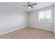 A bright bedroom featuring a ceiling fan, and a large window for ample natural light at 4935 Apollo Bay Dr, Highlands Ranch, CO 80130