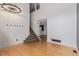 Bright entryway featuring hardwood floors, carpeted stairs, and modern lighting fixtures at 4935 Apollo Bay Dr, Highlands Ranch, CO 80130