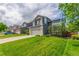 Two-story home featuring a two-car garage, a basketball hoop, and a well-maintained lawn on a suburban street at 4935 Apollo Bay Dr, Highlands Ranch, CO 80130