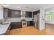 Stylish kitchen boasts stainless steel appliances, dark cabinets with sleek hardware, and modern backsplash at 4935 Apollo Bay Dr, Highlands Ranch, CO 80130
