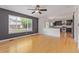 Inviting living room flowing into kitchen, showcasing hardwood floors and ample natural light at 4935 Apollo Bay Dr, Highlands Ranch, CO 80130