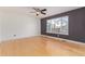 Bright living space features a ceiling fan, a large window offering natural light, and hardwood floors at 4935 Apollo Bay Dr, Highlands Ranch, CO 80130