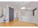 Open living space with hardwood floors, barn door access, and staircase leading to upper levels at 4935 Apollo Bay Dr, Highlands Ranch, CO 80130
