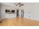 Spacious living room with hardwood floors offering access to the kitchen, barn door and entryway at 4935 Apollo Bay Dr, Highlands Ranch, CO 80130