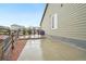 Exterior view of home side featuring a concrete patio, gravel bed, and wood fencing along the property line at 5128 Preserve Pl, Firestone, CO 80504