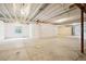 Bright unfinished basement featuring concrete flooring, white walls, and large windows, offering ample natural light at 5128 Preserve Pl, Firestone, CO 80504