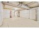 Unfinished basement with concrete floors, exposed utilities, and white wrapped walls ready for customization at 5128 Preserve Pl, Firestone, CO 80504